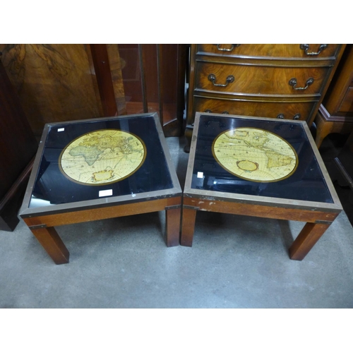 73 - A pair of teak and brass mounted occasional tables, inset with maps of the world