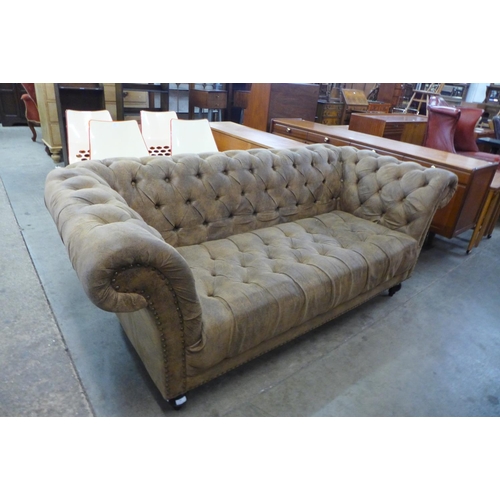 89 - A brown faux leather Chesterfield settee