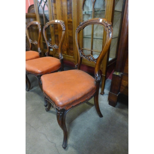 98 - A set of four Victorian carved walnut balloon back dining chairs