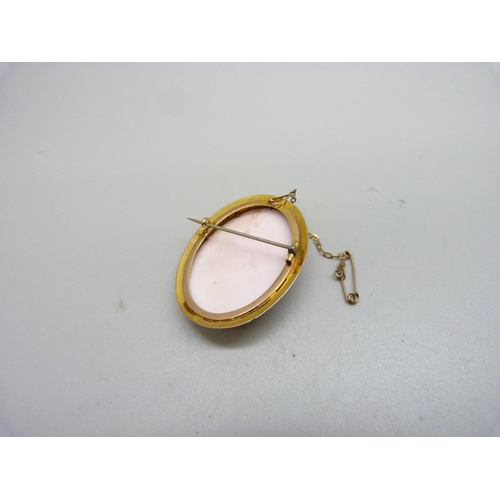 1035 - A large 9ct gold oval cameo, with safety chain, 14g