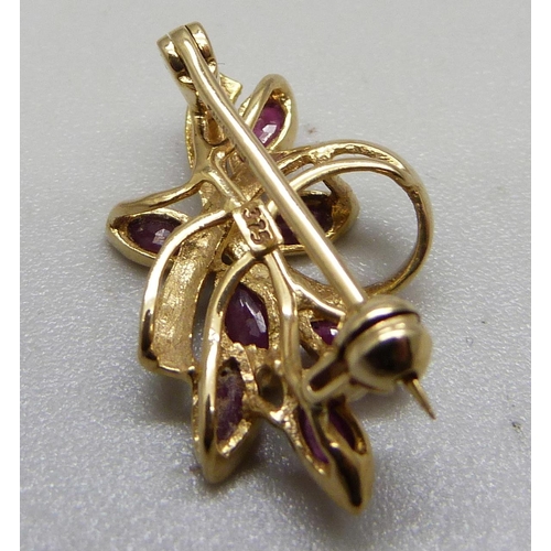 1044 - A 9ct gold and ruby brooch, 2g