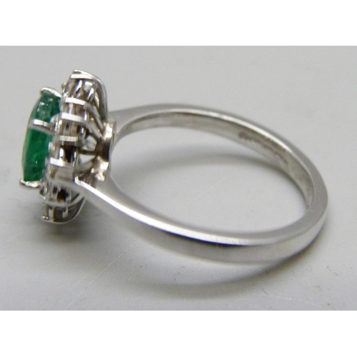 1061 - An 18ct white gold, emerald and diamond cluster ring, 4.5g, M, emerald approximately 6 x 8mm