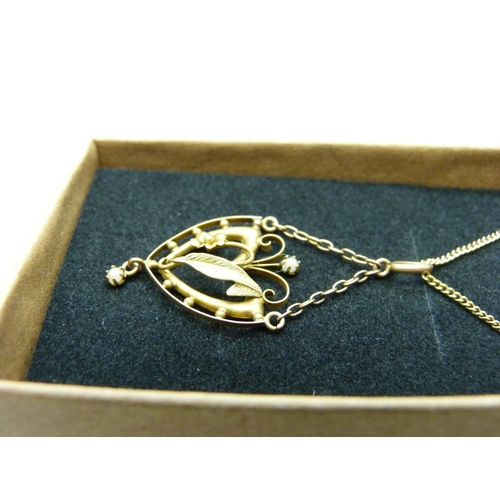 1066 - A 9ct gold and seed pearl pendant on a 9ct gold chain, 2.6g