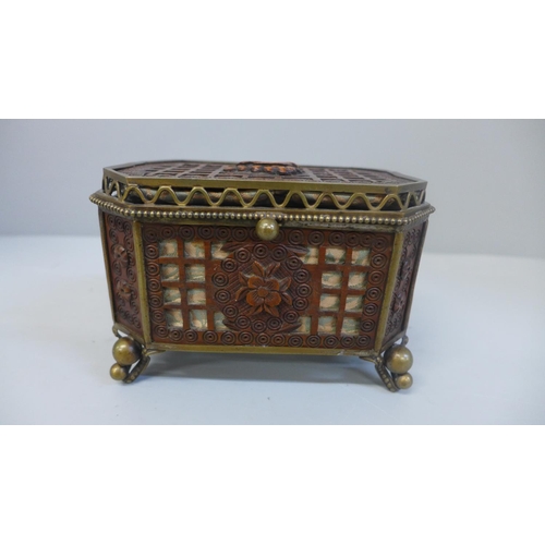 607 - An ornate mahogany openwork jewellery casket with brass fittings and silk lining, 13cm wide