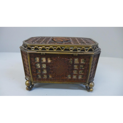 607 - An ornate mahogany openwork jewellery casket with brass fittings and silk lining, 13cm wide