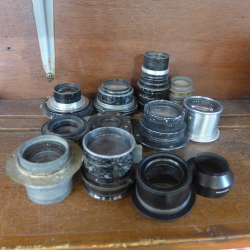 619 - A collection of eleven camera or magic lantern lenses