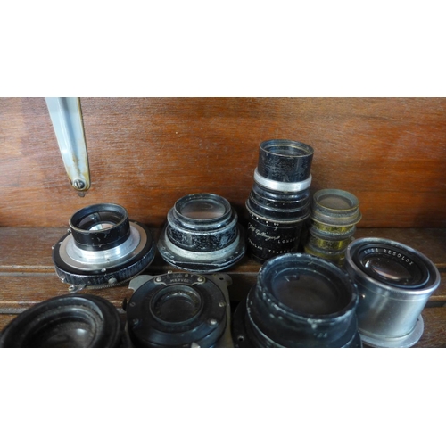 619 - A collection of eleven camera or magic lantern lenses