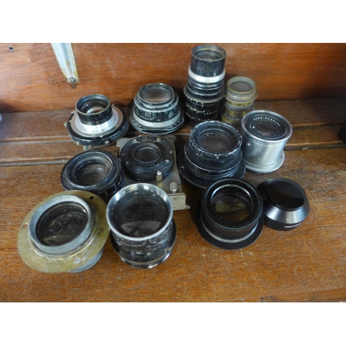 619 - A collection of eleven camera or magic lantern lenses