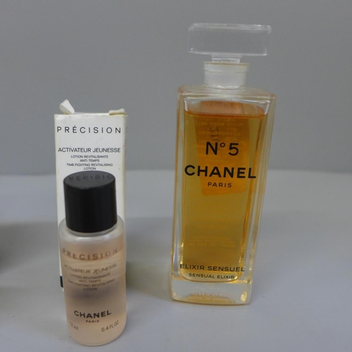 A bottle of Chanel No. 5 Elixir Sensuel perfume, revitalising lotion, one  empty bottle and a miniat