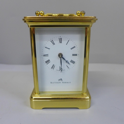 647 - A Matthew Norman brass cased and four glass sided carriage clock, with original box