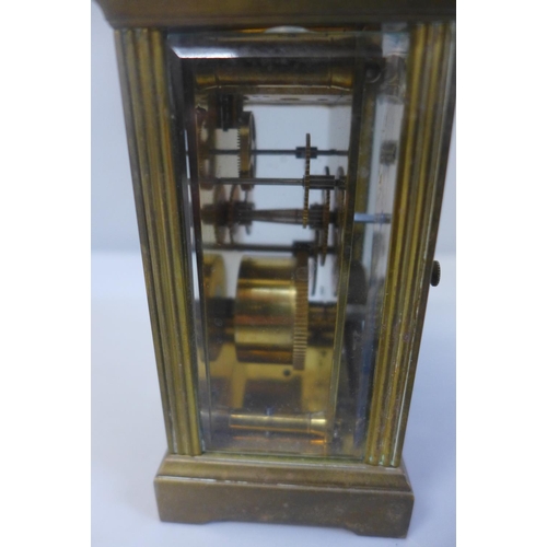 655 - A brass cased and four glass sided carriage clock with key