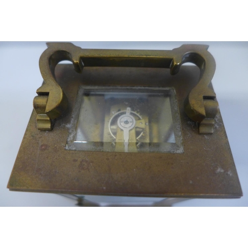 655 - A brass cased and four glass sided carriage clock with key