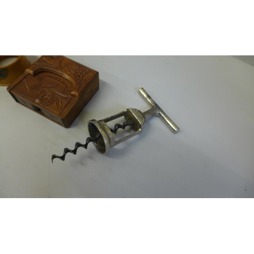 661 - A German Monapol corkscrew, circa 1910, an Austrian Grindlewald carved wood pocket watch stand and a... 