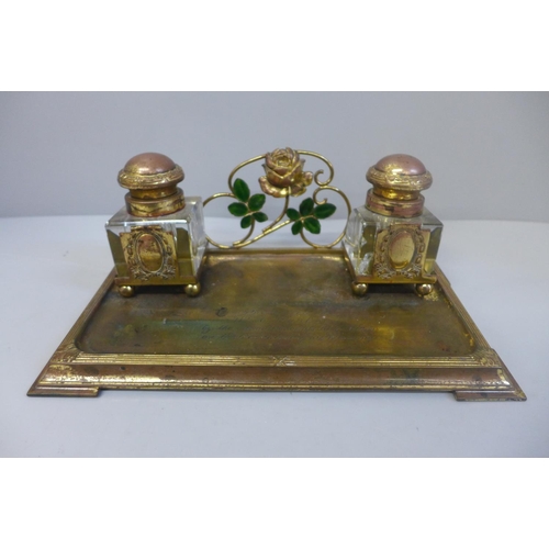 663 - A gilt metal ink stand with a pair of glass inkwells, with inscription