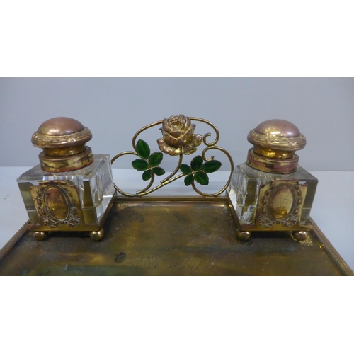 663 - A gilt metal ink stand with a pair of glass inkwells, with inscription