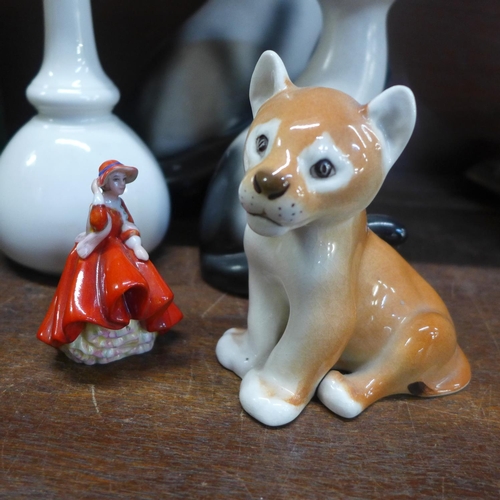 676 - Two Sylvac long neck cats, large and small, a USSR lion cub, a Royal Doulton figure, boxed and a Roy... 