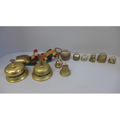 704 - Two brass door bells and a collection of cowbells