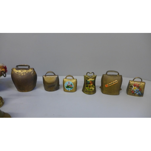 704 - Two brass door bells and a collection of cowbells