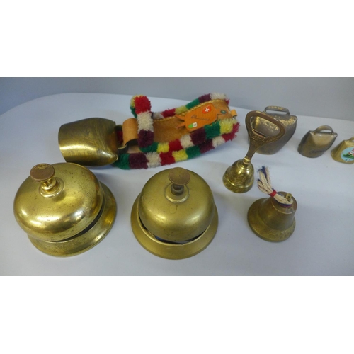 704 - Two brass door bells and a collection of cowbells