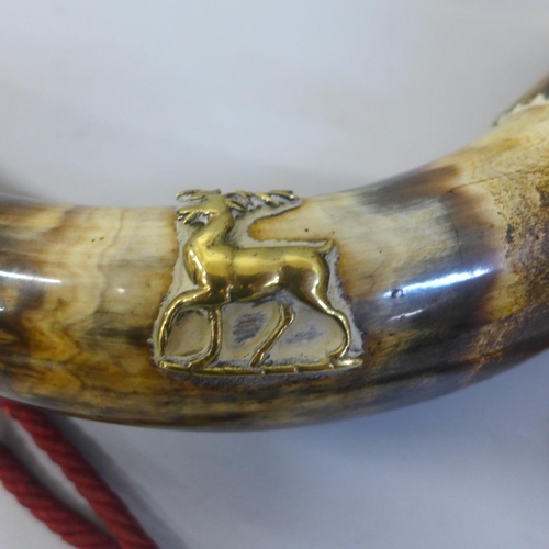 725 - A horn with brass embellishments and stag emblem