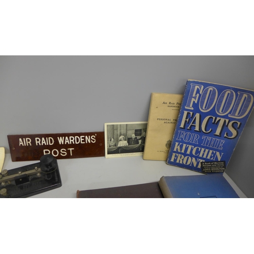 773 - Five WWII related books, a Morse Code tapper, a Bakelite sign, Air Raid Wardens' Post and an unissue... 