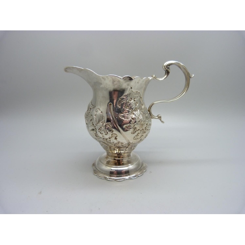 859 - An embossed silver cream jug, London 1762, 101g