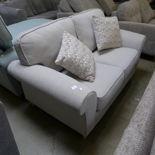 1524 - A sand upholstered two seater sofa