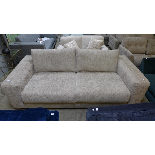 1569 - An oatmeal upholstered four seater sofa