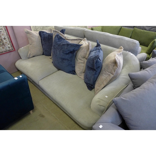 1592 - A cloud grey upholstered four seater sofa with scatter cushions (damaged feet)