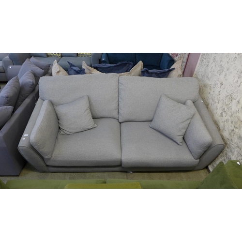 1598 - A stone grey upholstered 3.5 seater sofa - damaged feet