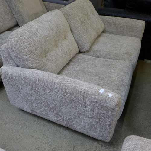 1602 - An oatmeal upholstered 2.5 seater sofa