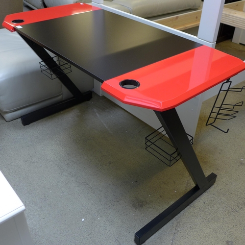 1631 - A Slade black and red gaming desk, slight damage