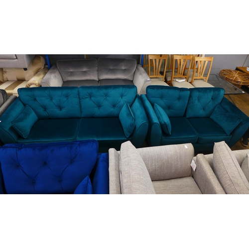 1486 - An emerald velvet three and two seater sofa