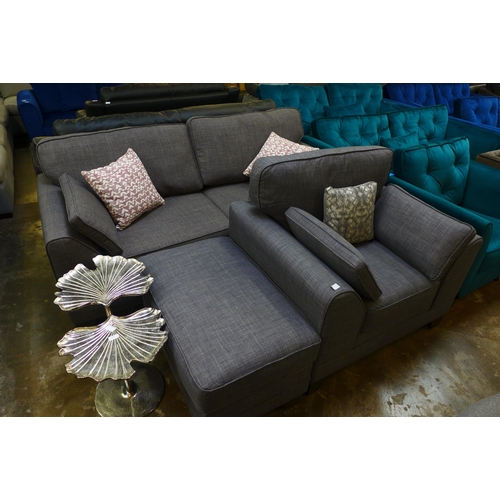 1500 - A shadow grey upholstered three seater sofa and armchair with footstool