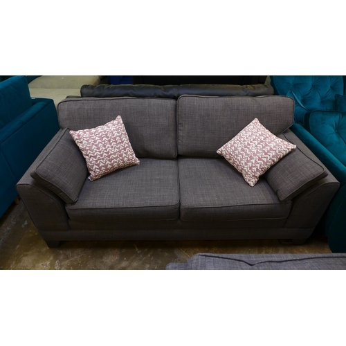 1500 - A shadow grey upholstered three seater sofa and armchair with footstool