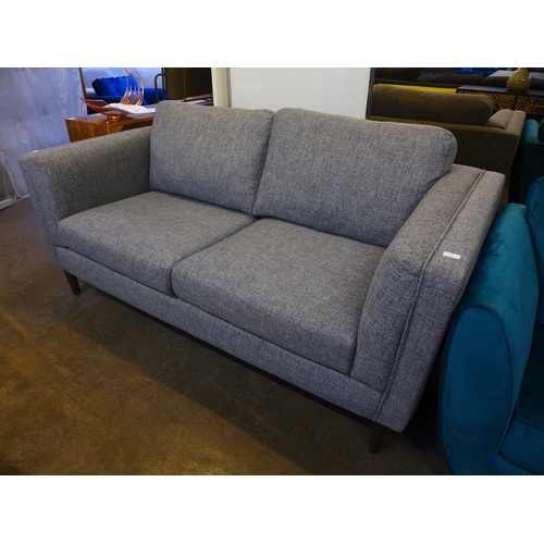 1560 - A stone grey upholstered three seater sofa