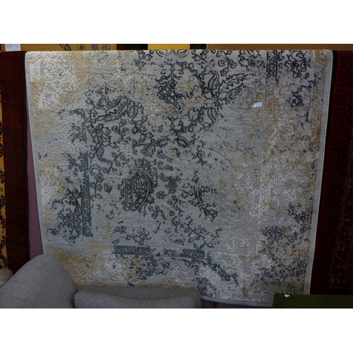 1599 - A gold and grey ground vintage style contemporary design rug, full pile, 230cm x 160cm