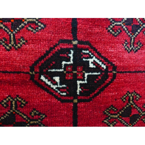 1600 - A rich red ground hand woven full pile Persian Nomadic rug, 203cm x 135cm