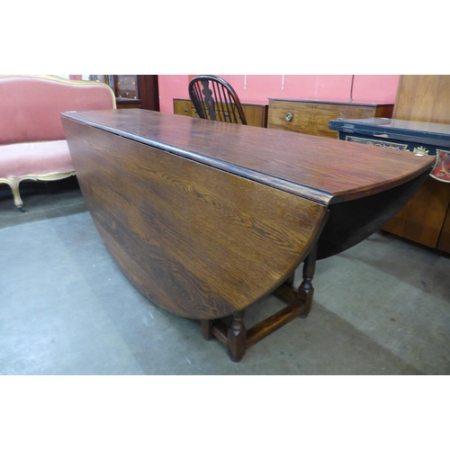 117 - A large George III style oak gateleg wake table