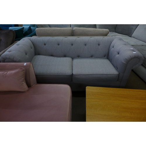 1477 - A grey Chesterfield upholstered three seater sofa