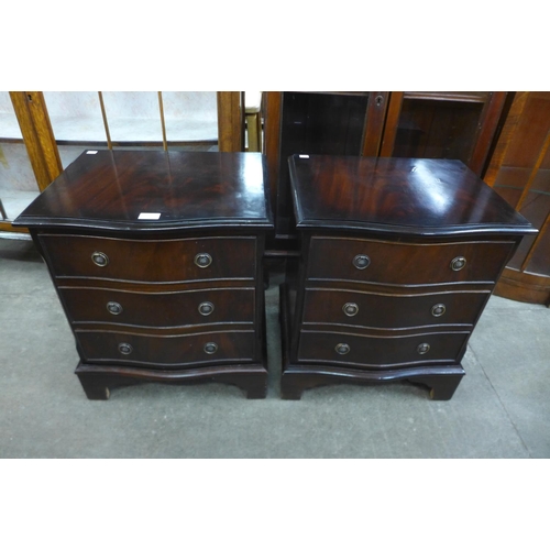 127 - A pair of small mahogany serpentine chests of drawers