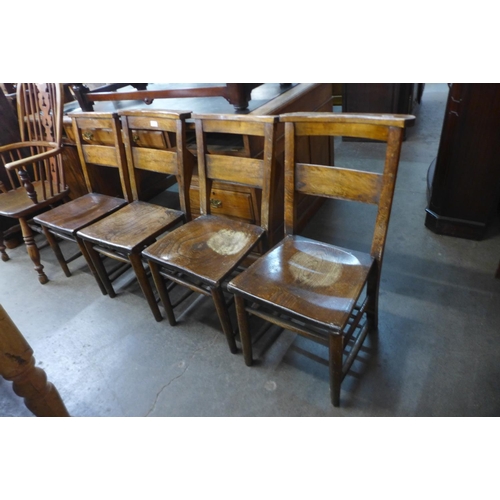 145 - A set of four early 20th Century elm and beech chapel chairs