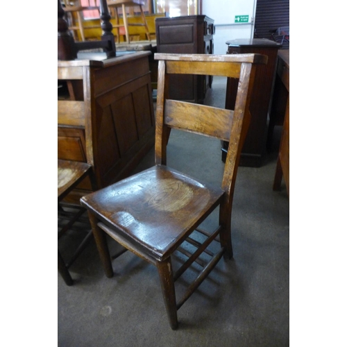 145 - A set of four early 20th Century elm and beech chapel chairs