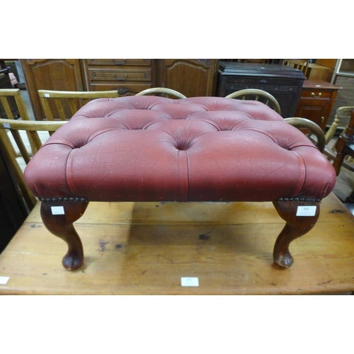 157 - An oxblood leather footstool