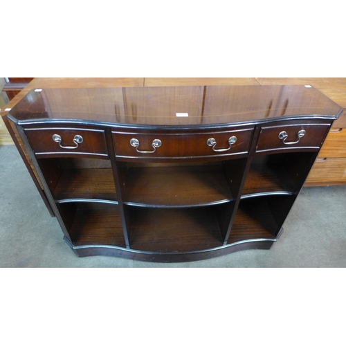 183 - An inlaid mahogany serpentine open bookcase