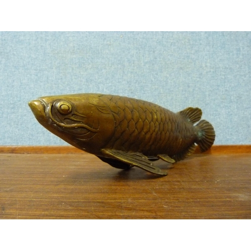 335A - An oriental bronze figure of a fish