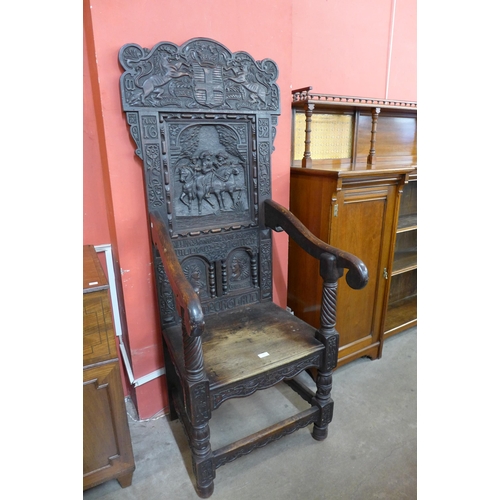 106 - A 17th Century style oak Wainsot chair, with extensive commemorative carving of William III victory ... 