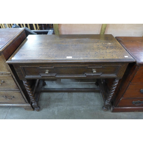 120 - An early 20th Century Jacobean Revival oak single drawer side table