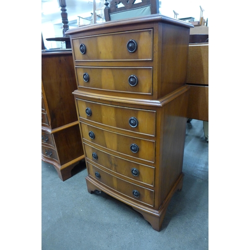 129 - A small yew wood bow front chest of drawers