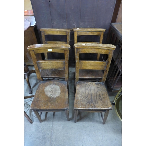 145 - A set of four early 20th Century elm and beech chapel chairs